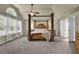Main bedroom features natural light, ceiling fan and four post bed at 3133 Bridge Walk Dr, Lawrenceville, GA 30044