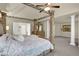 Spacious main bedroom with decorative four-post bed and tray ceiling at 3133 Bridge Walk Dr, Lawrenceville, GA 30044