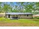 Backyard with covered patio, spacious lawn, and mature trees at 4158 Pepperdine Dr, Decatur, GA 30034
