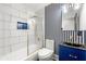 Stylish bathroom featuring a bathtub with shower, tile walls, vanity, mirror and modern fixtures at 4158 Pepperdine Dr, Decatur, GA 30034