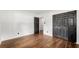 A bright bedroom featuring wood-look floors, fresh white walls, and a sizable closet with black doors at 4158 Pepperdine Dr, Decatur, GA 30034