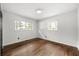 Bedroom featuring hardwood floors, white walls, and two sunny windows at 4158 Pepperdine Dr, Decatur, GA 30034