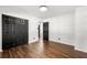 A bright bedroom featuring wood-look floors, fresh white walls, and a sizable closet with black doors at 4158 Pepperdine Dr, Decatur, GA 30034
