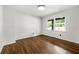 Bright bedroom featuring hardwood floors, white walls, and a sunny window at 4158 Pepperdine Dr, Decatur, GA 30034
