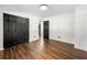 Bright bedroom featuring modern wood flooring, a ceiling light, and a closet with dark-colored doors at 4158 Pepperdine Dr, Decatur, GA 30034