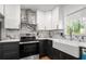 Remodeled kitchen with stainless steel appliances, and modern white and black cabinetry at 4158 Pepperdine Dr, Decatur, GA 30034