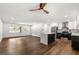 Open concept living room featuring dark hardwood floors, kitchen with island, and new windows at 4158 Pepperdine Dr, Decatur, GA 30034