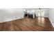 Bright living room showcasing hardwood floors leading into an open kitchen with white cabinetry and stainless steel appliances at 4158 Pepperdine Dr, Decatur, GA 30034