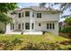 Exterior rear view featuring an elevated backyard with a patio at 725 Eider Down Ct, Alpharetta, GA 30022