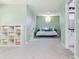 Cozy bedroom space with built-in shelves and a daybed next to a bathroom doorway at 725 Eider Down Ct, Alpharetta, GA 30022