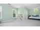 Comfortable bedroom featuring neutral colors, built-in shelves, and a daybed with decorative pillows at 725 Eider Down Ct, Alpharetta, GA 30022