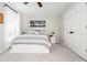 Bedroom featuring carpet, neutral walls, white bed, a modern white closet, and large windows at 725 Eider Down Ct, Alpharetta, GA 30022