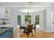 Sunlit breakfast nook offers views of the backyard and features hardwood floors and modern lighting at 725 Eider Down Ct, Alpharetta, GA 30022