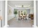 Charming dining area with piano, wainscoting, a modern light fixture, and outdoor view through a large window at 725 Eider Down Ct, Alpharetta, GA 30022
