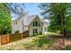 Exterior showcasing a home surrounded by mature trees and a fenced yard at 725 Eider Down Ct, Alpharetta, GA 30022