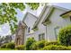 An elegant two-story home showcasing a combination of stone and stucco, enhanced by well-maintained shrubbery at 725 Eider Down Ct, Alpharetta, GA 30022
