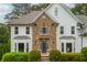 Charming two-story house featuring a stone-accented facade, bay windows, and manicured landscaping for curb appeal at 725 Eider Down Ct, Alpharetta, GA 30022