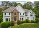 Stunning two-story home with a stone facade, arched window, lush landscaping, and an inviting entrance at 725 Eider Down Ct, Alpharetta, GA 30022