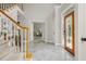 The foyer is adorned with tile floors, stained glass door, and staircase that enhances the home's elegance at 725 Eider Down Ct, Alpharetta, GA 30022