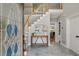 Bright foyer with tile floors, staircase, and stained glass door, creating a welcoming entrance to the home at 725 Eider Down Ct, Alpharetta, GA 30022