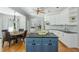 Bright kitchen features granite countertops, a blue island, and a breakfast nook with backyard views at 725 Eider Down Ct, Alpharetta, GA 30022