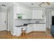 Open kitchen with desk space features modern white cabinets, granite counters, and stainless appliances at 725 Eider Down Ct, Alpharetta, GA 30022