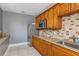Functional kitchen featuring wood cabinets, stainless steel appliances, and a practical layout for meal preparation at 725 Eider Down Ct, Alpharetta, GA 30022