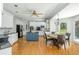 Spacious kitchen with island and breakfast nook featuring granite counters, white cabinetry and hardwood floors at 725 Eider Down Ct, Alpharetta, GA 30022