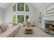 Bright living room features large windows, fireplace, and neutral decor at 725 Eider Down Ct, Alpharetta, GA 30022