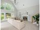 Inviting living room with fireplace, large windows, and high ceilings for a bright and airy feel at 725 Eider Down Ct, Alpharetta, GA 30022
