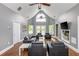 Cozy living room with high ceilings, ample seating, and a view of the community pool through French doors at 725 Eider Down Ct, Alpharetta, GA 30022