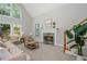 Elegant living room featuring a fireplace, comfortable seating, and views of the backyard at 725 Eider Down Ct, Alpharetta, GA 30022
