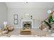 Cozy living room with fireplace, neutral decor, and a staircase leading to the upper level at 725 Eider Down Ct, Alpharetta, GA 30022