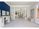 Open-concept living area with stylish furnishings, blue accent wall, and a clear view into the dining area at 725 Eider Down Ct, Alpharetta, GA 30022