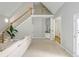 Spacious living room with fireplace, staircase, and bar area for entertaining guests at 725 Eider Down Ct, Alpharetta, GA 30022