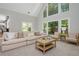 Spacious living room with vaulted ceiling, large windows, and a view to the kitchen at 725 Eider Down Ct, Alpharetta, GA 30022