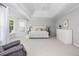 Large main bedroom with sitting area, fan and windows at 725 Eider Down Ct, Alpharetta, GA 30022