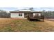 The house has white siding, a deck, a covered patio, and solar panels at 8268 E Carroll Rd, Whitesburg, GA 30185