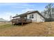 The house has white siding, a deck, a covered patio, and solar panels at 8268 E Carroll Rd, Whitesburg, GA 30185