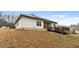 The house has white siding, a deck, a covered patio, and solar panels at 8268 E Carroll Rd, Whitesburg, GA 30185