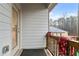 This balcony features sliding glass doors, vertical siding, and a brown wood rail at 8268 E Carroll Rd, Whitesburg, GA 30185