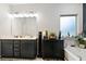 Bathroom featuring double vanity, soaking tub, and natural light at 8268 E Carroll Rd, Whitesburg, GA 30185