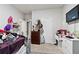 This bedroom features gray carpet, a white wall, a TV, and some furniture at 8268 E Carroll Rd, Whitesburg, GA 30185