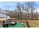 This deck is covered in green carpet and has a table, a couch, and grill at 8268 E Carroll Rd, Whitesburg, GA 30185