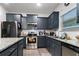 Well-equipped kitchen featuring granite countertops, stainless appliances, and modern cabinetry at 8268 E Carroll Rd, Whitesburg, GA 30185