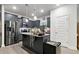 Open kitchen with large island, stainless steel appliances, and dark cabinets at 8268 E Carroll Rd, Whitesburg, GA 30185