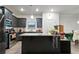 Open kitchen with island, stainless appliances, and modern cabinetry at 8268 E Carroll Rd, Whitesburg, GA 30185