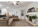 Open-concept living room with a fireplace feature, lots of natural light, and seamless flow to kitchen at 8268 E Carroll Rd, Whitesburg, GA 30185