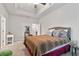 Bright main bedroom featuring tray ceilings, carpet flooring, and natural light at 8268 E Carroll Rd, Whitesburg, GA 30185