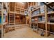 Attic used for storage, featuring wooden beams and shelving units, offering ample space for organization at 2490 Hillandale Cir, Cumming, GA 30041